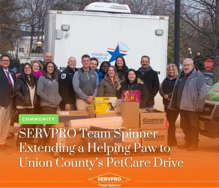 SERVPRO Team Spinner group photo behind the donated pet supplies